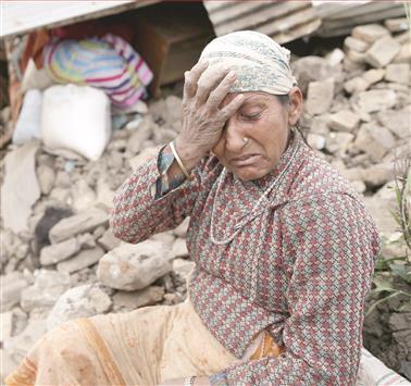 نيبالية تبكي أمام منزلها المدمر في قرية كومالبور على أطراف كاتماندو، أمس (أ ب أ)