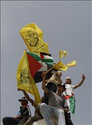 علم حركة «فتح» يُرفع للمرة الأولى منذ العام 2007 في ساحة الجندي المجهول في غزة خلال احتفال بالمصالحة أمس (أ ف ب) 
