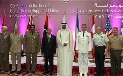ولي عهد قطر الشيخ تميم بن حمد وعبد الجليل يتوسطان قادة عسكريين خلال مؤتمر «أصدقاء ليبيا» في الدوحة أمس (أ ف ب) 