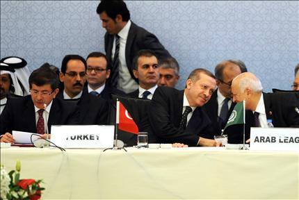 أردوغان يتحدث إلى العربي وإلى جانبهما داود أوغلو في مؤتمر «أصدقاء سوريا» في اسطنبول أمس (أ ف ب) 