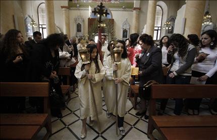 مسيحيون سوريون يحتفلون في كنيسة في دمشق أمس بعيد الشعانين (أ ب) 