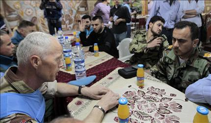 مود خلال لقائه القيادي في المجموعات المسلحة «أبو قتيبة» في حي الخالدية في حمص أمس (أ ف ب) 