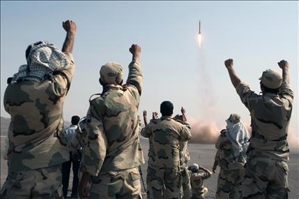 عناصر من الحرس الثوري يحتفلون بعد إطلاق صاروخ إيراني خلال مناورات أمس (أ ب) 