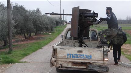 مسلحون على خط المواجهة بالقرب من قاعدة تفتناز في ريف إدلب، أمس الأول (رويترز) 