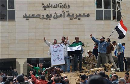 متظاهرون يحتفلون أمام مديرية الأمن بعد سيطرة الجيش عليها في بورسعيد أمس (أ ف ب) 