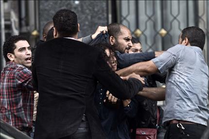 عناصر أمن بالزي المدني يعتقلون متظاهرين امام مقر مجلس الشورى في القاهرة امس (أ ف ب) 