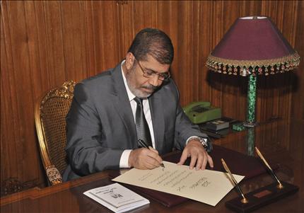 مرسي يوقع مرسوماً رئاسياً بدخول الدستور الجديد حيز التنفيذ في القاهرة أمس (رويترز)
