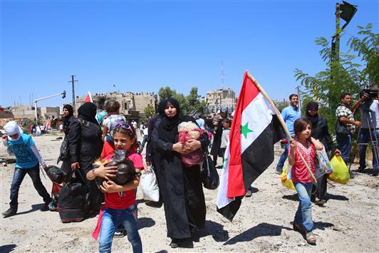 سوريون خلال عودتهم الى حي القدم في دمشق أمس (ا ف ب)