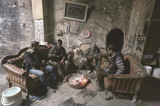 مسلحون داخل منزل في حي قسطل الحرامي في حلب امس (ا ف ب)