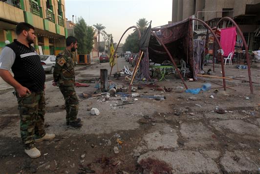 آثار التفجير الذي وقع في شارع فلسطين في العاصمة العراقية بغداد، أمس. (أ ف ب)