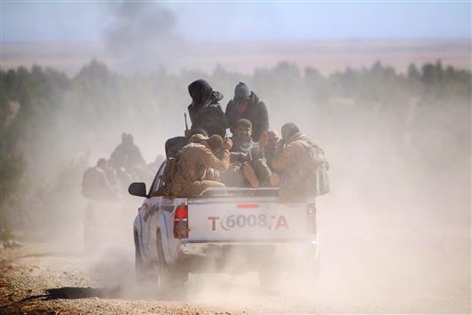 مسلحون من «قوات سوريا الديموقراطية» خلال توجههم الى الشدادي في محافظة الحسكة امس الاول (رويترز)