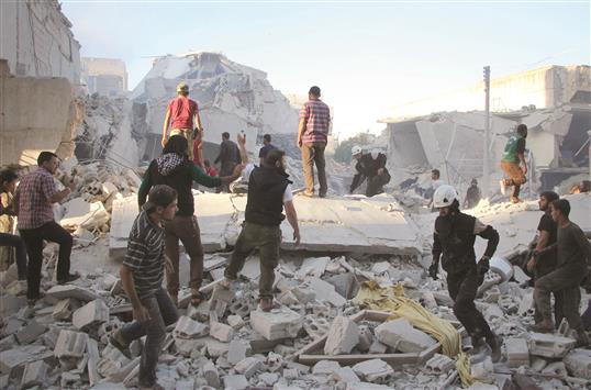 سوريون يبحثون عن ناجين بين ركام أبنية مدمّرة في إدلب (ا ف ب)