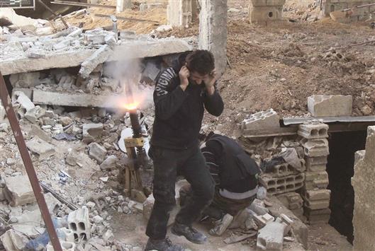 مسلحان من «فيلق الرحمن» يقصفان من جوبر القوات السورية على اطرافها امس الاول (رويترز)