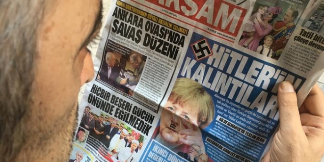 صحيفة تركية تنشر صورة لميركل بشارب هتلر مع الصليب المعقوف