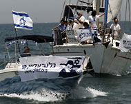 إسرائيليون يحملون صورة شاليط في عملية احتجاج بشاطئ هرتزيليا ضد أسطول الحرية.
