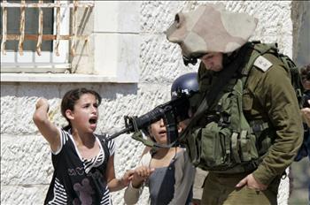 طفلة فلسطينية تصرخ في وجه جندي من الاحتلال خلال تظاهرة احتجاج على توسيع مستوطنة «حالاميش» في قرية النبي صالح في الضفة الغربية أمس